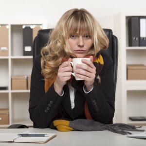 Young girl at work enjoying hot coffee