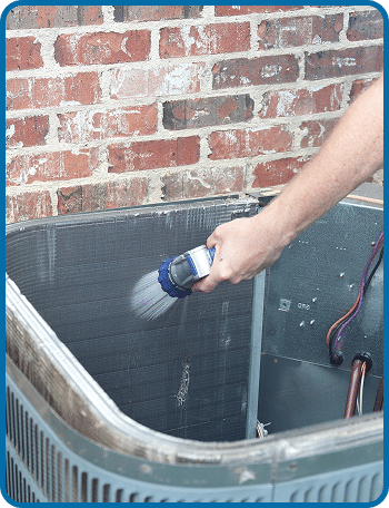 AC coil being cleaned
